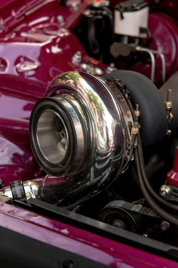 Close-up of a shiny chrome turbocharger on a car engine